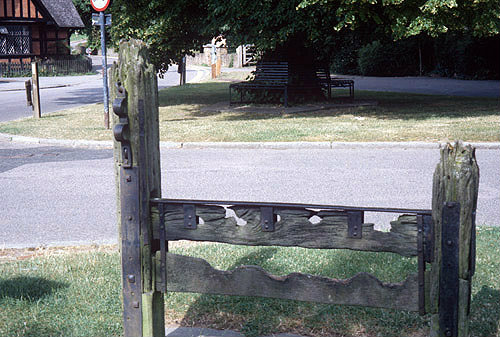 Village stocks in foreground, Albury Village, Hertfordshire, England